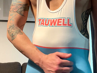 Smooth jock in wrestling singlet jerks off and cums